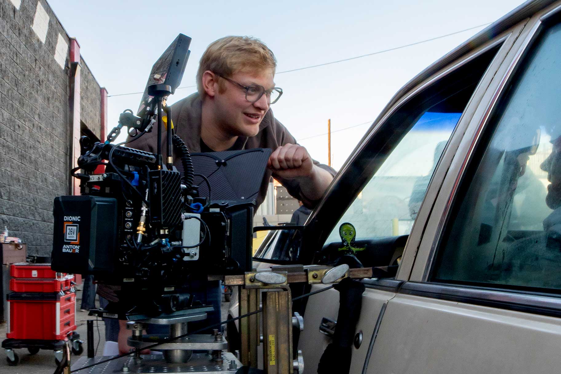 Curry Barker working beside a camera rig on the set of Obsession